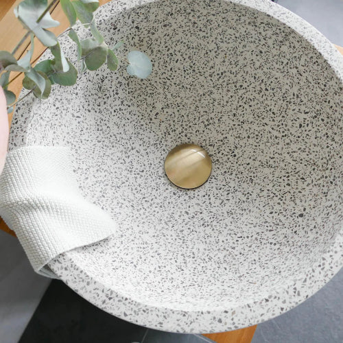 ronde terrazzo waskom met een gouden plug