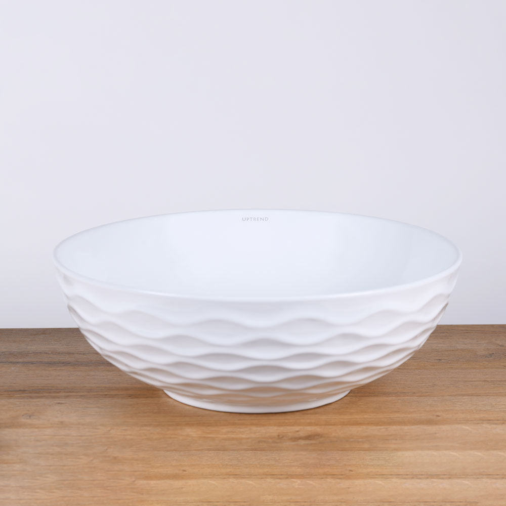 Ronde witte keramische opbouwwaskom 42x42x14cm met subtiel golvend reliëf en gladde binnenzijde, ideaal voor een moderne en rustige badkamerstijl